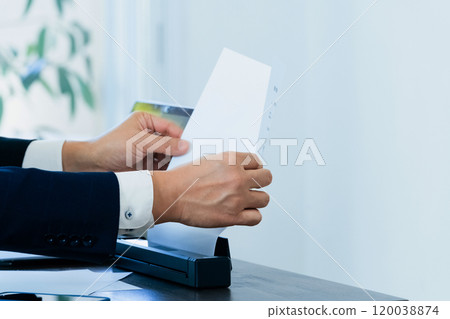 The hands of a male business man scanning documents The hands of a male business man scanning documents 120038874