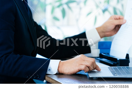 The hands of a male business man scanning documents The hands of a male business man scanning documents 120038886