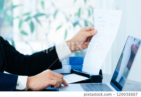 The hands of a male business man scanning documents 120038887