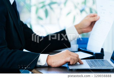 The hands of a male business man scanning documents The hands of a male business man scanning documents 120038888