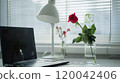 Create a stylish and productive workspace with a minimalist white lamp and fresh flowers 120042406