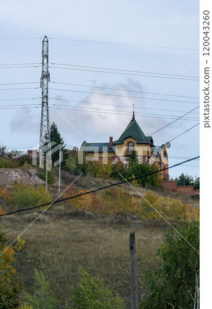 Residential buildings on the mountain behind power lines. Residential buildings on the mountain behind power lines. 120043260