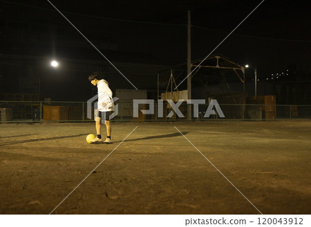 Children playing soccer in the park at night 120043912