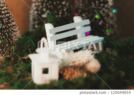 A warm winter scene with a white bench and lanterns 120044654