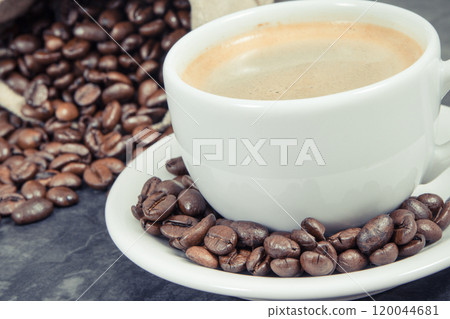 Coffee in cup and roasted dark coffee beans in bag Coffee in cup and roasted dark coffee beans in bag 120044681