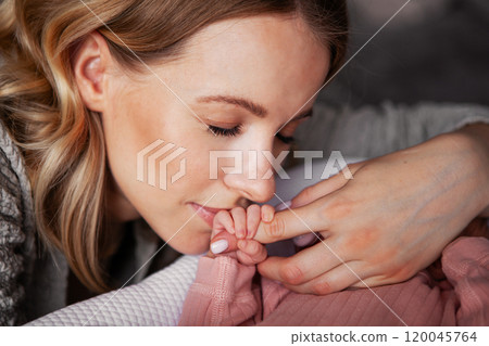 Beautiful Mother Gently Kissing Tiny Hand and Fingers of Newborn Baby, Heartfelt Moment of Love and Affection Beautiful Mother Gently Kissing Tiny Hand and Fingers of Newborn Baby, Heartfelt Moment of Love and Affection 120045764