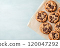 Top view of chocolate chip cookies on a solid background. 120047292
