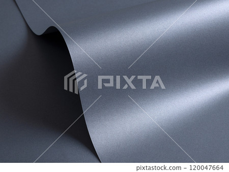 Glossy designer paper background with a metallic slate gray gradient, featuring a wavy, reflective 120047664