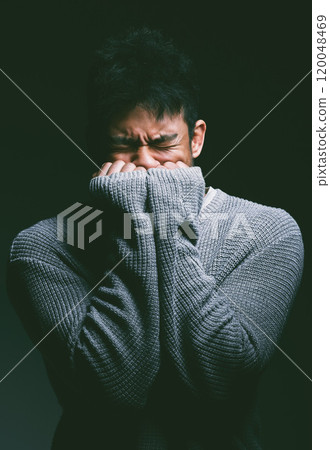 Stress, crying and man in dark studio with hands on face in fear, nightmare and mental health trauma. Angry, scared and frustrated person with depression, anxiety and terror on black background Stress, crying and man in dark studio with hands on face in fear, nightmare and mental health trauma. Angry, scared and frustrated person with depression, anxiety and terror on black background 120048469