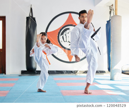 Child, teacher or kick in martial arts dojo for training, fighting exercise or karate club education. Learning skill, practice or judo master with girl kid in studio for taekwondo lesson or workout 120048529