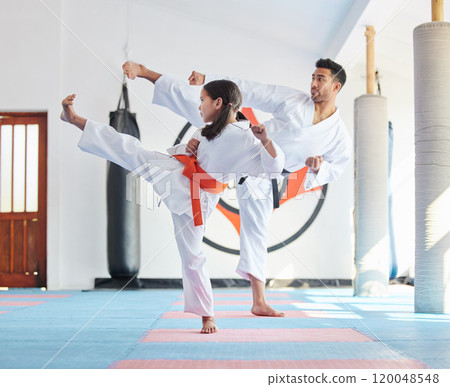 Kid, master or kick in martial arts dojo for training, fighting exercise or karate club education. Learning skill, practice or judo teacher with girl child in studio for taekwondo lesson or workout Kid, master or kick in martial arts dojo for training, fighting exercise or karate club education. Learning skill, practice or judo teacher with girl child in studio for taekwondo lesson or workout 120048548