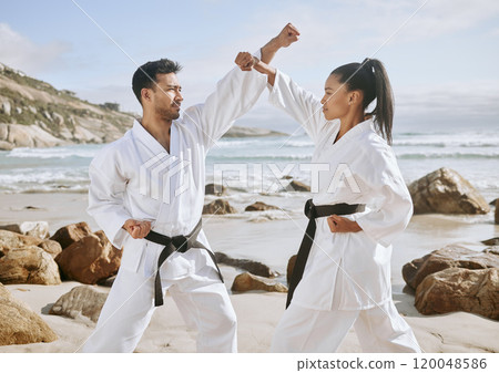 Karate, martial arts and people on beach for fight, practice and learning aikido, taekwondo and jiujitsu. Sports, nature and man and woman by ocean for fitness, exercise and training for tai chi 120048586