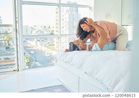 Couple, laugh or bed in hotel for love, romance or vacation for anniversary. Man, woman or bonding in guest house bedroom for trust, commitment or passion on holiday for milestone celebration in city 120048615