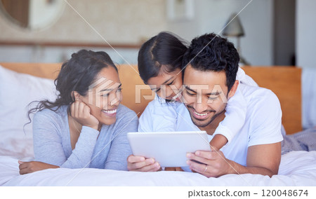 Family, girl and tablet for morning cartoon in bedroom, wake up and streaming together in home. Parents, daughter and hug dad for love in bed to watch movie, online games and reading ebook on weekend 120048674