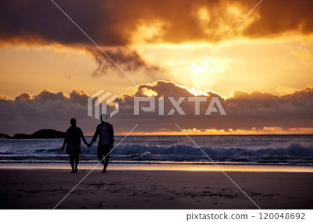 Sunset, seaside and couple with love, holding hands and romance with tropical island, travel and honeymoon. Beach, golden hour and man with woman, relationship and holiday for anniversary or vacation Sunset, seaside and couple with love, holding hands and romance with tropical island, travel and honeymoon. Beach, golden hour and man with woman, relationship and holiday for anniversary or vacation 120048692