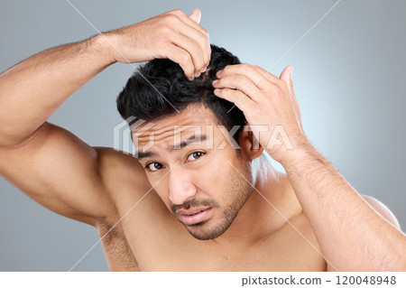 Hair care, dandruff or portrait of man in studio for dry scalp treatment, worry or grooming. Male person, concern or stress on gray background for coconut oil, salicylic acid and remedy for head itch 120048948
