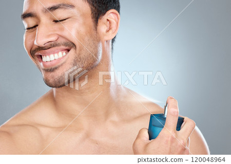 Cologne, smile and man spraying neck against a gray studio background. Wellness, care and health of topless model with cosmetic product for grooming, clean skin and smell routine for body hygiene Cologne, smile and man spraying neck against a gray studio background. Wellness, care and health of topless model with cosmetic product for grooming, clean skin and smell routine for body hygiene 120048964