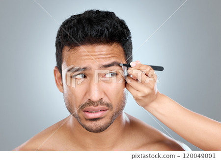 Eyebrow, pain and man with tweezers in studio for hair removal, hygiene and facial treatment. Skincare, beauty and person anxious with tool for epilation, self care and grooming on white background Eyebrow, pain and man with tweezers in studio for hair removal, hygiene and facial treatment. Skincare, beauty and person anxious with tool for epilation, self care and grooming on white background 120049001
