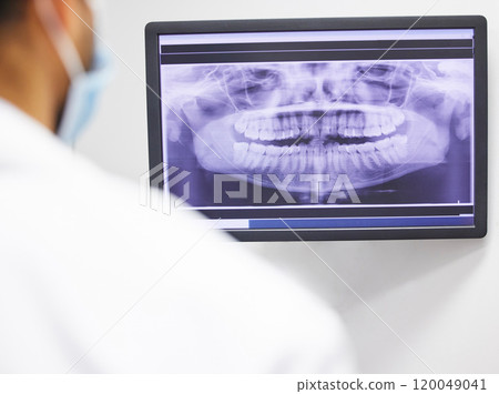 Dentist, consultation and x ray of teeth on screen for anatomy education, dental diagnosis and treatment planning. Oral assessment, person and monitor with image for hygiene, health and wellness 120049041