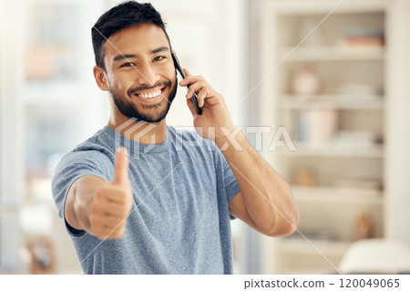 Portrait, phone call and man with thumbs up in living room for communication, success or agreement. Contact, smile and person with hand gesture for achievement, conversation or loan approval in home 120049065