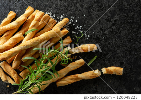 Homemade grissini breadsticks with sea salt and rosemary. 120049225