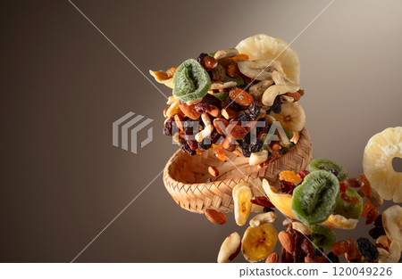 Dried tropical fruits with various nuts and raisins in motion. Dried tropical fruits with various nuts and raisins in motion. 120049226