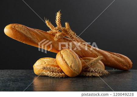 Baguette and French buns on a black background. Baguette and French buns on a black background. 120049228