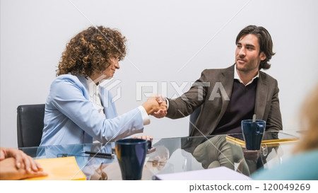 Business partners shaking hands during conference meeting 120049269