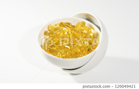 Transparent yellow vitamins on a light background. Vitamin D, omega 3, omega 6, Food supplement oil filled fish oil, vitamin A, vitamin E, flaxseed oil. 120049421