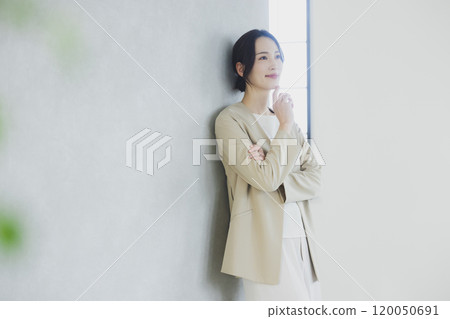Young woman in a suit with her arms crossed 120050691