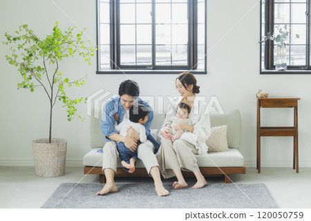 Young family, parents and children, living room Young family, parents and children, living room 120050759