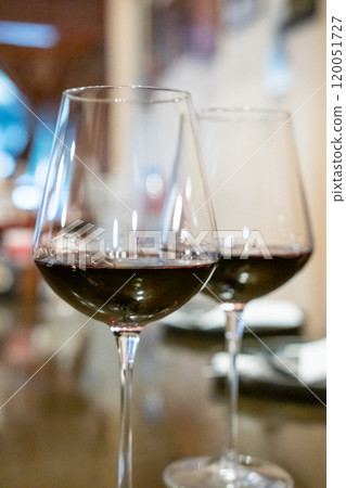 Two glasses of red wine on the table, with blur background in the restaurant 120051727