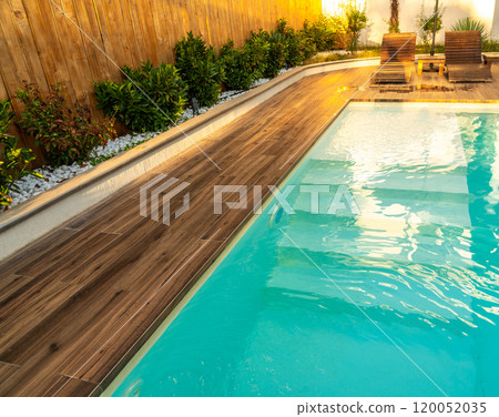 Swimming pool entrance steps with clean blue water at modern villa Swimming pool entrance steps with clean blue water at modern villa 120052035