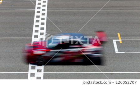 Motion blur race car racing on speed track, Car race on the international circuit race track crossing start and finish line, Race car crossing start and finish line, Target business achieve victory. Motion blur race car racing on speed track, Car race on the international circuit race track crossing start and finish line, Race car crossing start and finish line, Target business achieve victory. 120052707
