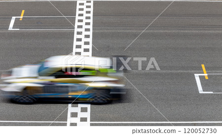 Motion blur race car racing on speed track, Car race on the international circuit race track crossing start and finish line, Race car crossing start and finish line, Target business achieve. 120052730
