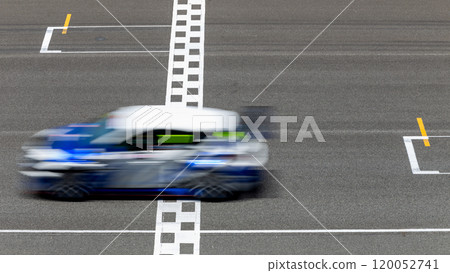 Motion blur race car racing on speed track, Car race on the international circuit race track crossing start and finish line, Race car crossing start and finish line, Target business achieve. Motion blur race car racing on speed track, Car race on the international circuit race track crossing start and finish line, Race car crossing start and finish line, Target business achieve. 120052741