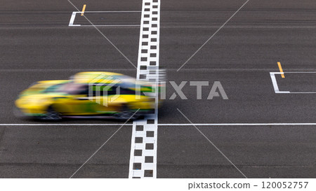 Motion blur race car racing on speed track, Car race on the international circuit race track crossing start and finish line, Race car crossing start and finish line, Target business achieve. 120052757