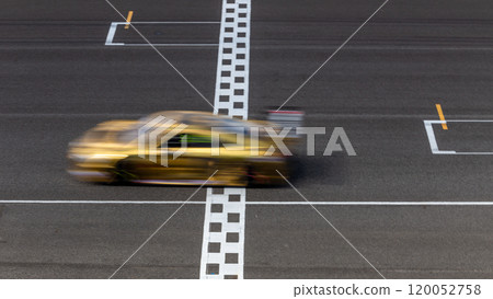 Motion blur race car racing on speed track, Car race on the international circuit race track crossing start and finish line, Race car crossing start and finish line, Target business achieve. 120052758
