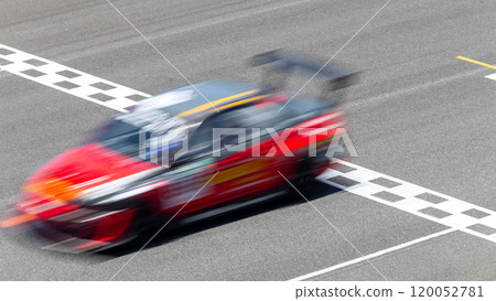 Motion blur race car racing on speed track, Car race on the international circuit race track crossing start and finish line, Race car crossing start and finish line, Target business achieve victory. 120052781