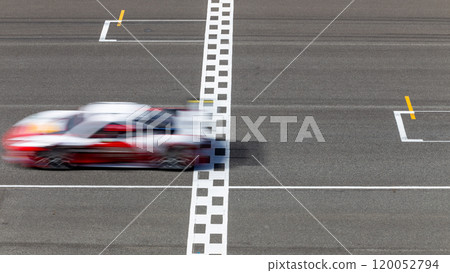 Motion blur race car racing on speed track, Car race on the international circuit race track crossing start and finish line, Race car crossing start and finish line, Target business achieve. 120052794
