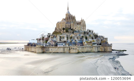 Mont Saint-Michel, Normandy northern France with tourists exploring tidal sands 120053694