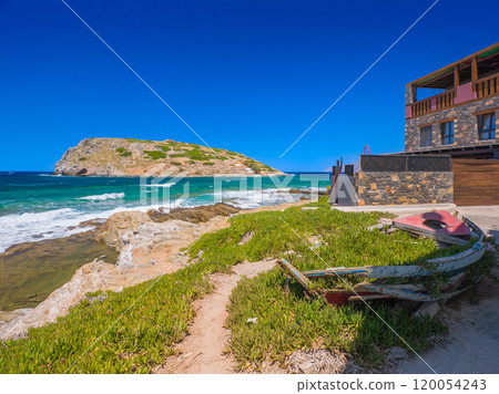 An old abandoned, overgrown boat on a sandy beach and an island with Minoan ruins on the opposite shore (Mochlos, Crete, Greece) An old abandoned, overgrown boat on a sandy beach and an island with Minoan ruins on the opposite shore (Mochlos, Crete, Greece) 120054243