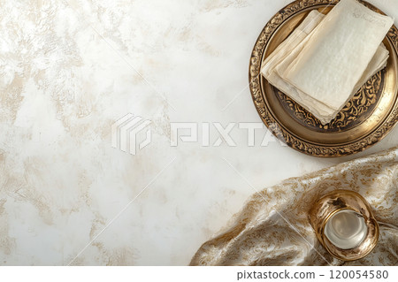 Elegant arrangement of silver plate with vintage cloths and candle on textured white background 120054580