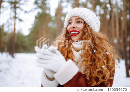 Winter smiling woman stands among snowy trees in winter forest. Winter smiling woman stands among snowy trees in winter forest. 120054670