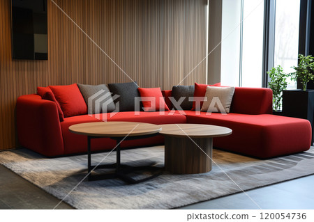 Modern red sectional sofa with contrasting cushions and round coffee table in a stylish living room 120054736