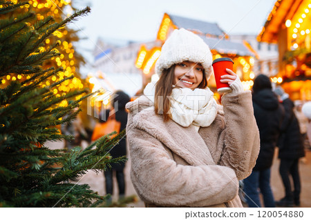 Woman enjoying winter moments. Festive Christmas fair, winter holidays concept. 120054880