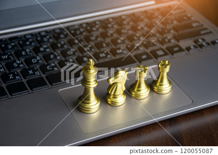 Golden chess king placed on laptop, corporate leadership concept 120055087