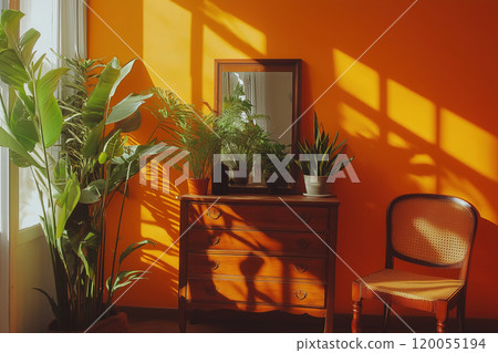 A cozy corner with a wooden dresser, potted plants, and sunlight casting shadows in a bright orange A cozy corner with a wooden dresser, potted plants, and sunlight casting shadows in a bright orange 120055194