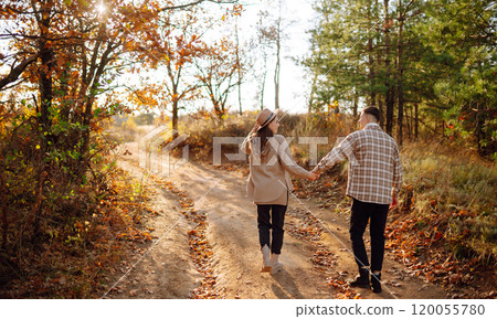 Stylish couple walking and enjoying autumn weather. People, lifestyle, vacations concept. Autumn. 120055780