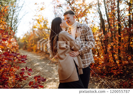 Couple in love newlyweds in casual clothes travel together, hike and walk in autumn forest in nature 120055787